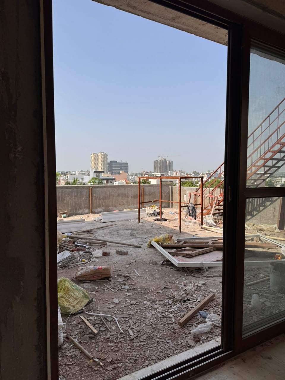 Terrace level with installed sliding glass doors and external metal staircase at our Sector 41F Noida kothi