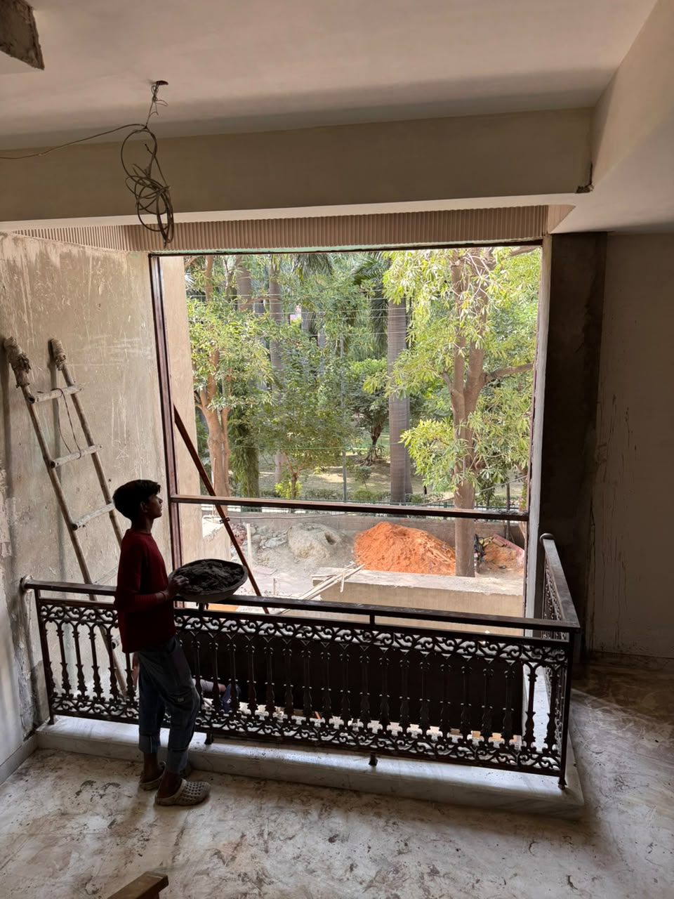 Mortar patching beside a cast-iron railing on the upper floor of our Sector 41F Noida kothi